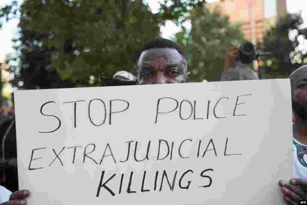 People rally in Dallas, Texas, on Thursday, July 7, 2016 to protest the deaths of Alton Sterling and Philando Castile.