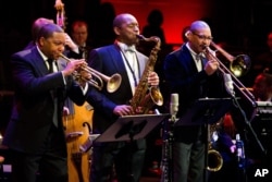 FILE - Musicians Wynton Marsalis, left, Branford Marsalis, center, and Delfeayo Marsalis perform at the National Endowment for the Arts Jazz Master Awards Ceremony and Concert held in New York, Jan. 11, 2011.