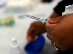 A Johnson and Johnson booster vaccine is prepred at the Vaccination Centre of Hope at the Cape Town International Convention Centre in Cape Town, South Africa on Nov. 30, 2021, as part of the Sisonke trial for healthcare workers.