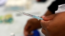 A Johnson and Johnson booster vaccine is prepred at the Vaccination Centre of Hope at the Cape Town International Convention Centre in Cape Town, South Africa on Nov. 30, 2021, as part of the Sisonke trial for healthcare workers.