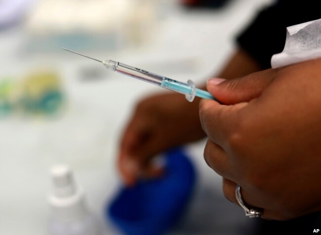 A Johnson and Johnson booster vaccine is prepred at the Vaccination Centre of Hope at the Cape Town International Convention Centre in Cape Town, South Africa on Nov. 30, 2021, as part of the Sisonke trial for healthcare workers.