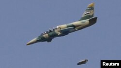 A Syrian Air Force fighter jet launches missiles at El Edaa district in Syria's northwestern city of Aleppo, September 1, 2012.