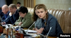 FILE - Public figure Maria Butina (R) attends a meeting of a group of experts, affiliated to the government of Russia, in this undated handout photo obtained by Reuters on July 17, 2018.