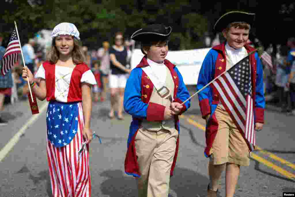 Children in costumes march down Main Street during the annual Fourth of July parade in Barnstable Village on Cape Cod, Massachusetts.