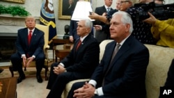 President Donald Trump listens to a question during a meeting with Finnish President Sauli Niinisto in the Oval Office of the White House in Washington, Aug. 28, 2017. From left are, Trump, Vice President Mike Pence, and Secretary of State Rex Tillerson.