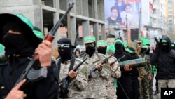 Masked militants from a military wing of Hamas commemorate the 29th anniversary of their group, in Gaza City, Dec. 14, 2016. 