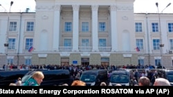 In this imag taken from a footage provided by the Russian State Atomic Energy Corporation ROSATOM press service, people gather for the funerals of five Russian nuclear engineers killed by a rocket explosion in Sarov, the closed city 370 kilometers east of Moscow.