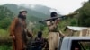 FILE - Pakistani Taliban patrol in Shawal, in the Pakistani tribal region of South Waziristan, Aug. 5, 2012. 