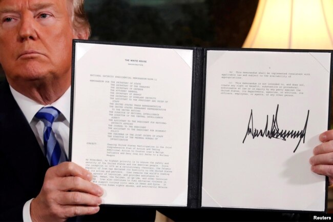 FILE - U.S. President Donald Trump holds up a proclamation declaring his intention to withdraw from the JCPOA Iran nuclear agreement after signing it in the Diplomatic Room at the White House in Washington, May 8, 2018.