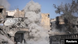 Smoke rises after a landmine is exploded as fighters of Syrian Democratic Forces clear roads after the liberation of Raqqa, Syria, Oct. 18, 2017. 