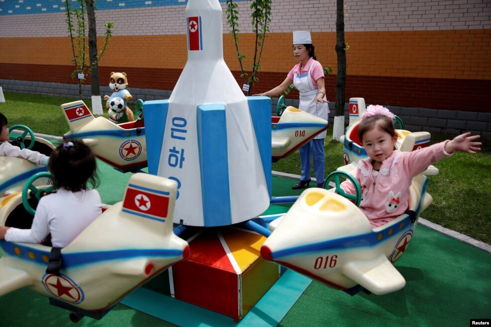 Children enjoy a rocked themed merry-go-around during government organised visit for foreign reporters to the Kim Jong Suk Pyongyang textile mill in Pyongyang, North Korea.