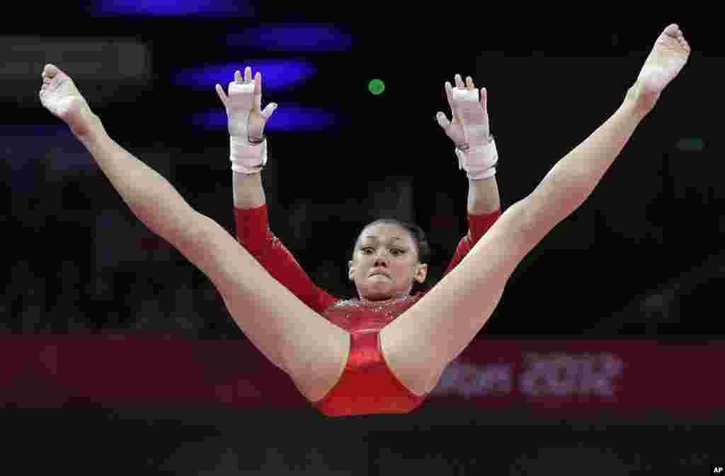 U.S. gymnast Kyla Ross performs on the uneven bars during the Artistic Gymnastics women's team final at the 2012 Summer Olympics, July 31, 2012, in London. 
