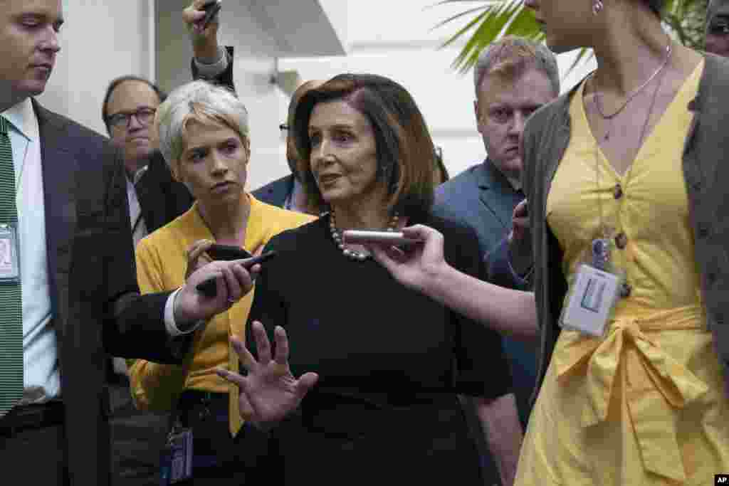 Speaker of the House Nancy Pelosi, D-Calif., is surrounded by reporters as she arrives to meet with her caucus at the Capitol in Washington, after declaring she will launch a formal impeachment inquiry against President Donald Trump.