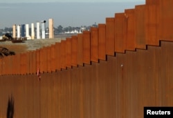 The prototypes for U.S. President Donald Trump's border wall are seen behind the border fence between Mexico and the United States, in Tijuana, Mexico, Jan. 7, 2019.