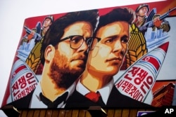 A banner for "The Interview," a firm whose release has been delayed by Sony Pictures, is posted outside Arclight Cinemas in Hollywood, California, Dec. 17, 2014