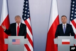 FILE - U.S. President Donald Trump, left, speaks during a news conference with Polish President Andrzej Duda at Royal Castle in Warsaw, July 6, 2017.