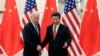 Chinese President Xi Jinping, right, shakes hands with U.S Vice President Joe Biden, left, as they pose for photos at the Great Hall of the People in Beijing, Dec. 4, 2013. 