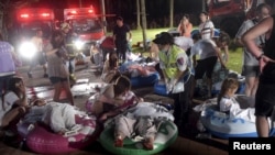 Victims injured in an explosion during a music concert lie on rafts at the Formosa Water Park in New Taipei City, Taiwan, June 27, 2015.