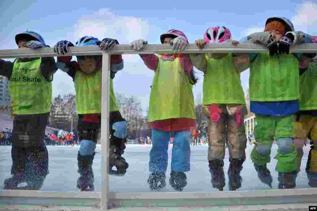Children learn to skate at the Seoul Square skating rink, South Korea.