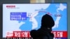 A man watches a TV screen showing a local news program reporting North Korea's missile launch at the Seoul Train Station in Seoul, South Korea, Nov. 29, 2017.