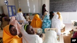 FILE - Children displaced by Boko Haram receive lessons in a school in Maiduguri, Nigeria, Dec. 7, 2015.