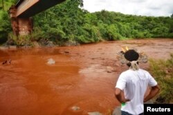 An Indigenous man from the Pataxo Ha-ha-hae tribe looks at Paraopeba river, after a tailings dam owned by Brazilian mining company Vale SA collapsed, in Sao Joaquim de Bicas near Brumadinho, Brazil, Jan. 25, 2019.