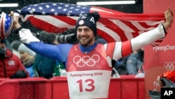 Chris Mazdzer of United States celebrates his silver medal win during final heats of the men's luge competition at the 2018 Winter Olympics in Pyeongchang, South Korea, Sunday, Feb. 11, 2018. (AP Photo/Wong Maye-E)