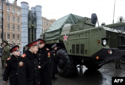 FILE – Russian cadets pass an S-300 surface-to-air missile system during a military exhibition in St. Petersburg, Feb. 20, 2015. Russia announced later that year that it would deliver missile systems that Iran had contracted for in 2007.