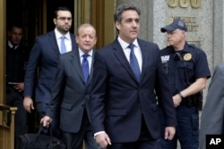 President Donald Trump's personal attorney Michael Cohen (R) and his attorney Stephen Ryan (2nd-L) leave Federal Court, in New York, May 30, 2018.