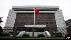 FILE - A Chinese national flag flutters in front of the Shanghai's No. 1 People's Intermediate Court in Shanghai, China.