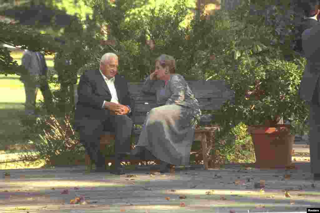 Israel's Foreign Minister Ariel Sharon sits on a bench with U.S. Secretary of State Madeleine Albright during the Middle East peace summit at the Wye River Conference Center, Oct. 18, 1998.