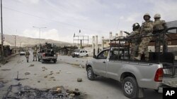 Pakistan paramilitary troops patrol at the site of an attack by gunmen, in Quetta, Pakistan, Saturday, April 14, 2012.