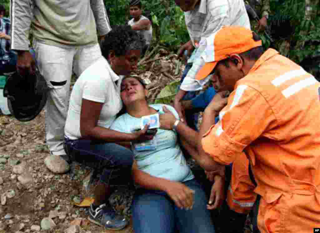 January 26: Rescue workers comfort Caterine Zapata, center, wife of mine worker Jorge Lara, outside La Preciosa mine in northeastern Colombia. Lara is among 20 miners feared dead after a gas explosion rocked the underground coal mine early Wednesday. Meth