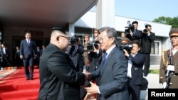 South Korean President Moon Jae-in shakes hands with North Korean leader Kim Jong Un as he leaves after their summit at the truce village of Panmunjom, North Korea.