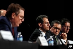 FILE - U.S. Trade Representative Robert Lighthizer, left, speaks while Mexico's Chief Technical Negotiator Kenneth Smith, Mexico's Secretary of Economy Ildefonso Guajardo Villarreal, and Mexico's Undersecretary of Foreign Trade Juan Carlos Baker, listen during a news conference, Aug. 16, 2017, at the start of NAFTA renegotiations in Washington.