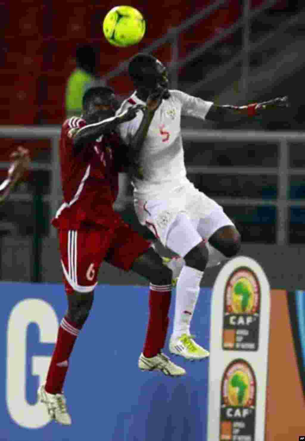 Mohamed Koffi of Burkina Faso (R) fights for the ball with Mosaab Omar of Sudan during their African Nations Cup Group B soccer match at Estadio de Bata "Bata Stadium", in Bata January 30, 2012.