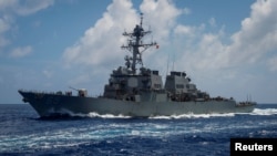 FILE - The Arleigh Burke-class guided-missile destroyer USS Benfold transits the Philippine Sea, June 14, 2018. The ship has also sailed recently through the Taiwan Strait.