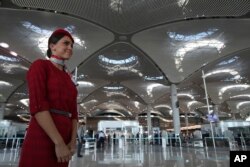 An airline employee stands in Istanbul's new airport ahead of its opening, Oct. 29, 2018.