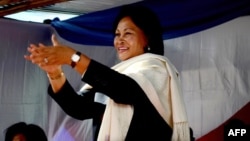 Wife of ex-president Marc Ravalomanana, Lalao Ravalomanana (C) applauds during an electoral meeting on May 4, 2013 in Antananarivo at "the Magro", a supermarket owned by her husband.