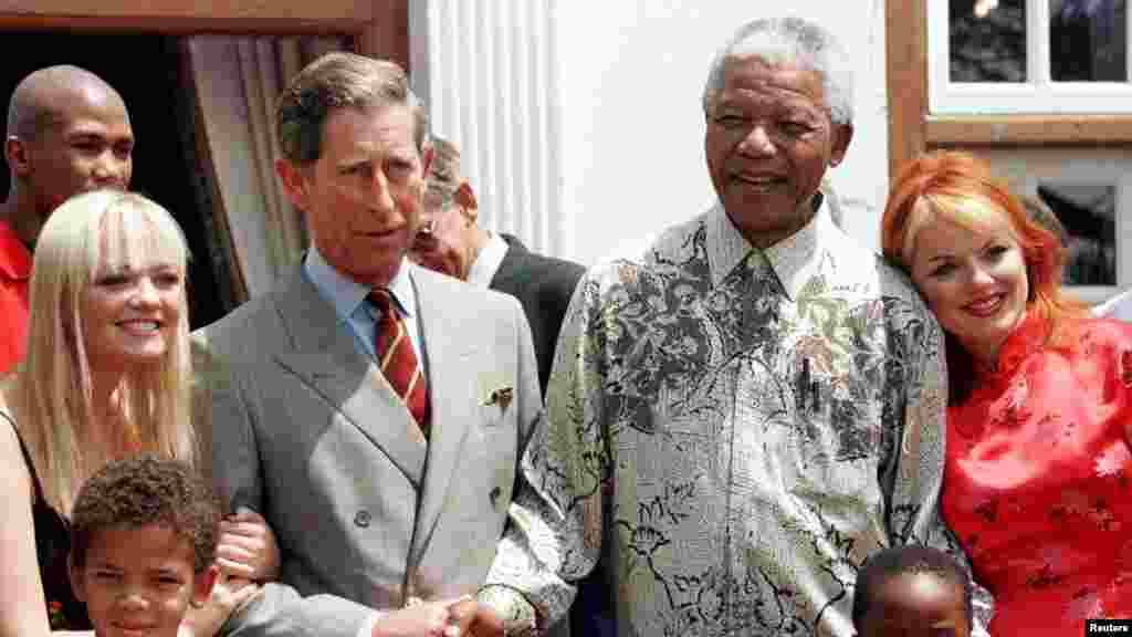 President Nelson Mandela and Britain&#39;s Prince Charles shake hands alongside members of the Spice Girls&#39; Emma (L), and Gerri (R) at Mr. Mandela&#39;s residence November 1, 1997.
