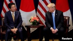 FILE - U.S. President Donald Trump listens to Japan's Prime Minister Shinzo Abe during a meeting on the sidelines of the 73rd session of the U.N. General Assembly in New York, Sept. 26, 2018.