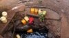 FILE - A woman fetches water from a well near Marsabit in northern Kenya, Sept. 16, 2014. A Kenyan university student from Marsabit County has won a grant to help track expectant mothers in the area.