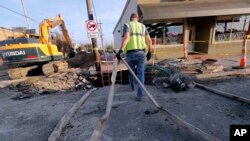 Workers fix a sewer main below the sidewalk in Mid City New Orlean, Jan. 31, 2018. The city of New Orleans is perhaps one of the best examples of what President Donald Trump calls the country’s “crumbling infrastructure.” City officials say New Orleans needs more than $11 billion to update key parts of its infrastructure.