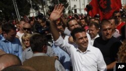 Zoran Zaev, center, the leader of the opposition Social Democrats, waves to the supporters during a protest in Skopje, Macedonia, May 17, 2015.
