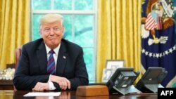 US President Donald Trump listens during a phone conversation with Mexico's President Enrique Pena Nieto