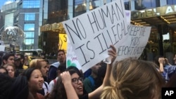 Protesters rally outside the Trump International Hotel and Tower in New York to protest the Trump administration's decision to end a program protecting young immigrants from deportation, Sept. 9, 2017. Many people attending the rally said the program has helped them. 