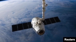 FILE - The SpaceX Dragon cargo capsule approaches the International Space Station prior to installation in this NASA picture taken April 10, 2016.