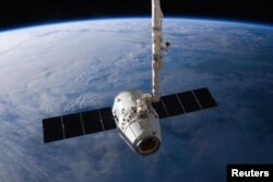 FILE - A SpaceX Dragon cargo capsule approaches the International Space Station prior to installation in this NASA picture taken April 10, 2016.