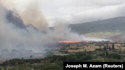 Smoke rises as a wildfire spreads in Kaanapali, Maui, Hawaii, Aug. 24, 2018 in this still image taken from a video obtained from social media.
