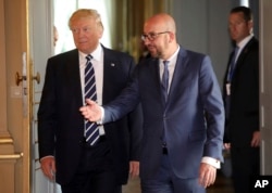 U.S. President Donald Trump speaks with Belgian Prime Minister Charles Michel prior to a meeting at the Royal Palace in Brussels, May 24, 2017.